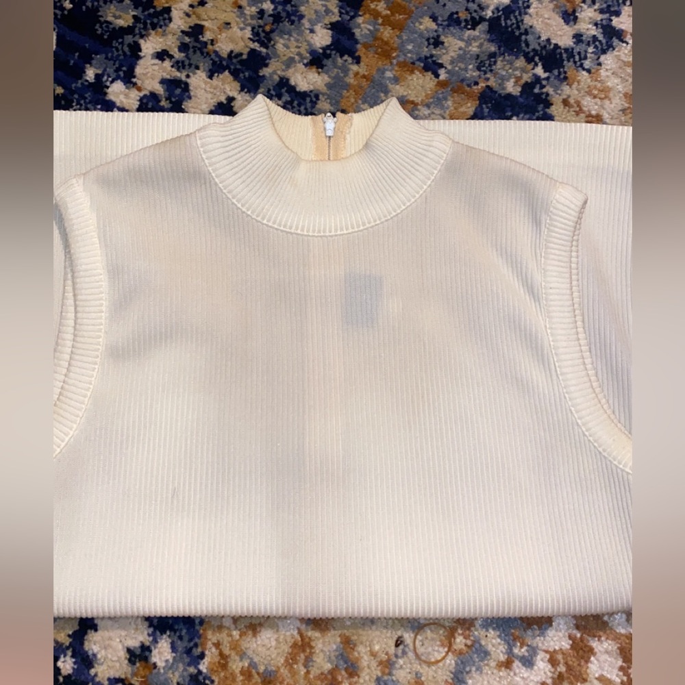 A cream color vest